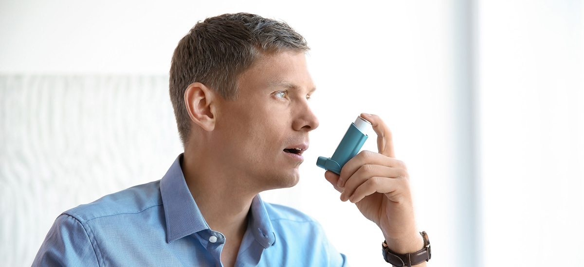 Slide Image od man using a blue inhaler