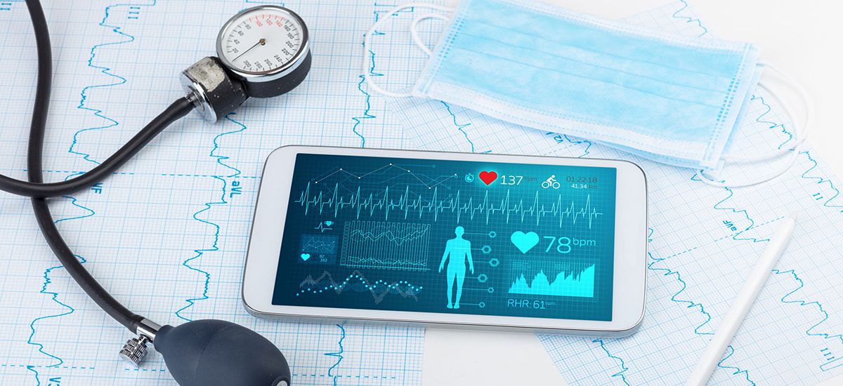 Slide Image -   sphygmomanometer, smartphone, heart trace print-outs and medical mask.