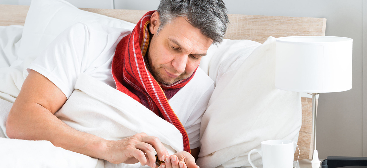 Slide Image of a man in bed using a smartphone